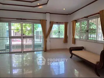 Spacious living room with large windows and elegant seating