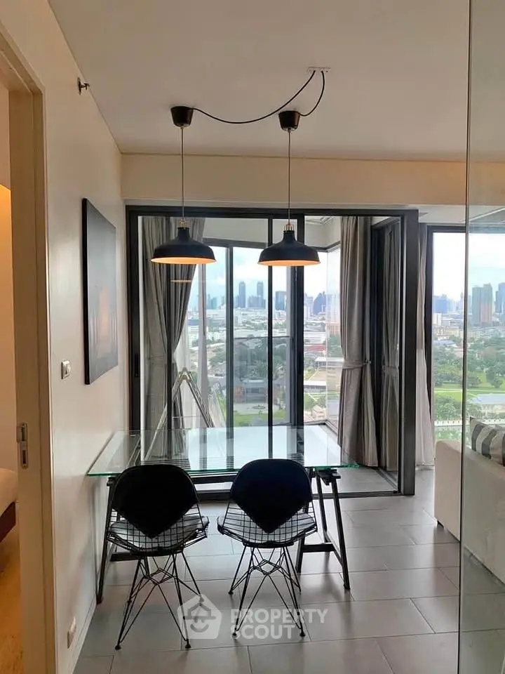 Modern dining area with glass table and city view in stylish apartment