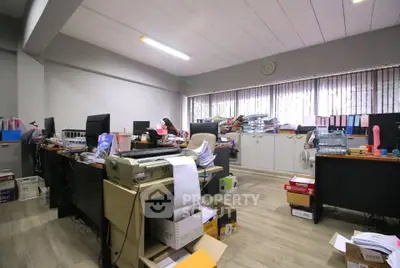 Spacious office space with ample natural light and organized workstations
