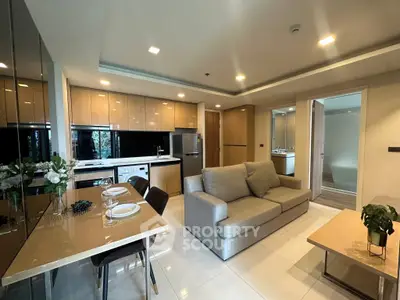 Modern open-plan living room and kitchen with sleek design and cozy ambiance.