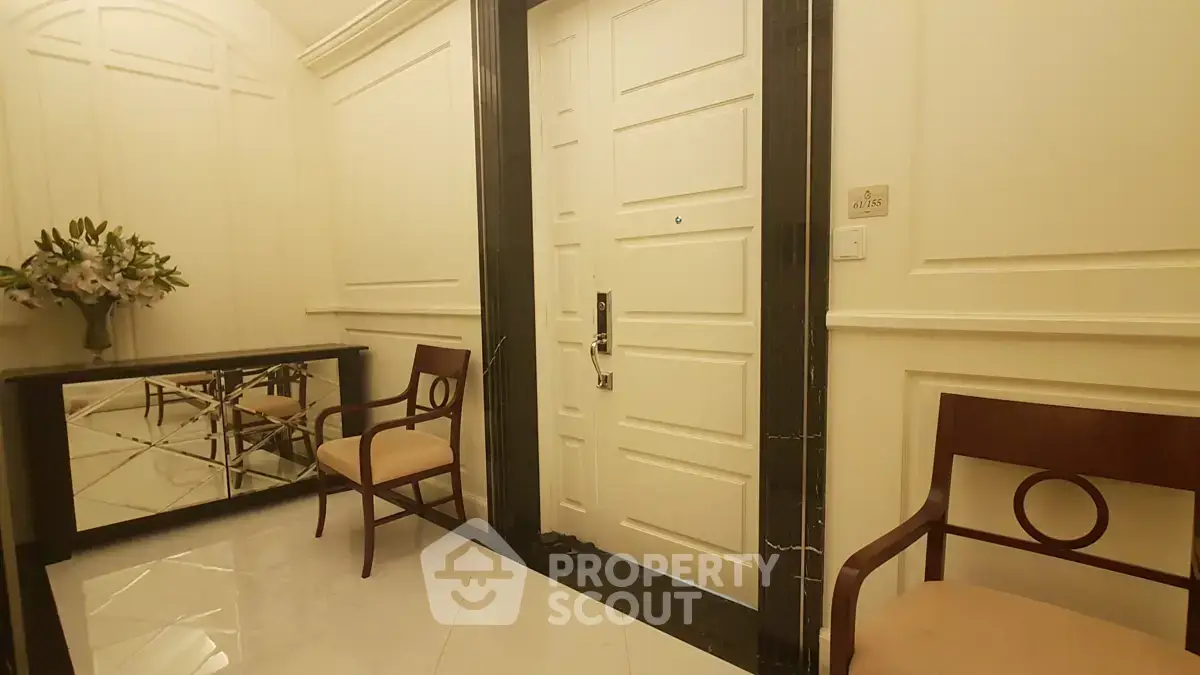Elegant apartment entrance with stylish chairs and mirror decor