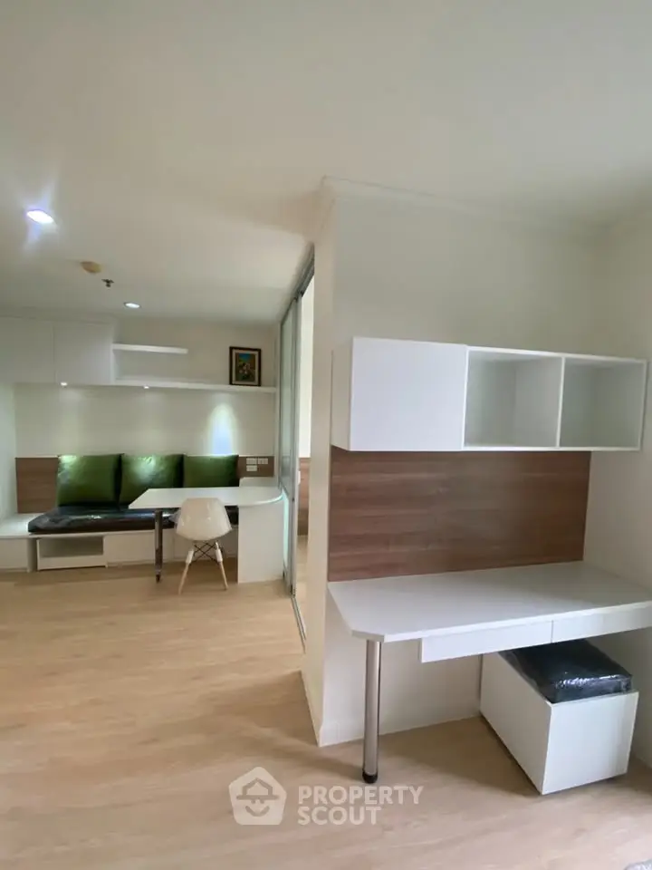 Modern study area with sleek white desk and shelving, perfect for productivity.