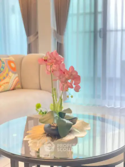 Elegant living room with stylish decor and glass coffee table