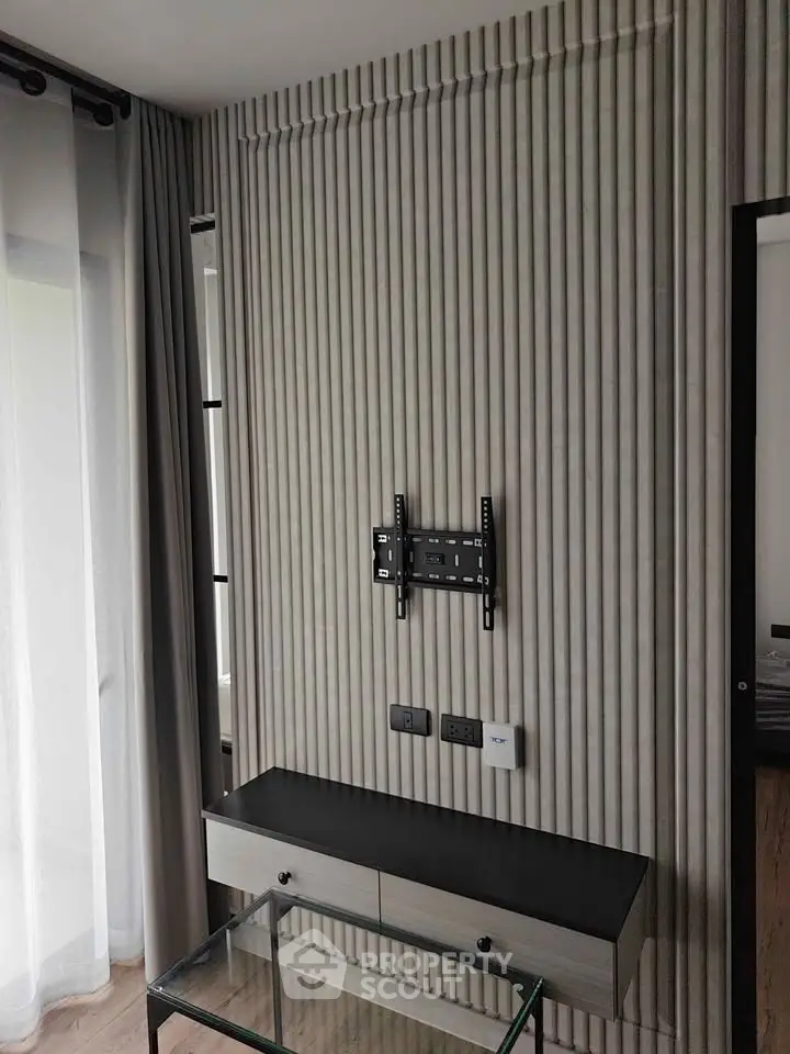 Modern interior wall with TV mount and sleek console table in stylish apartment.