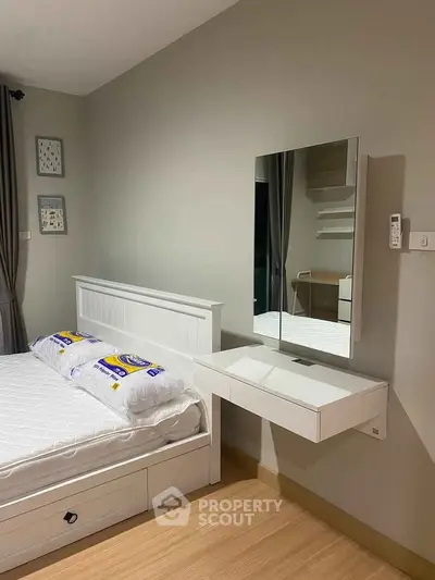 Modern bedroom with sleek design featuring a floating vanity and stylish decor.