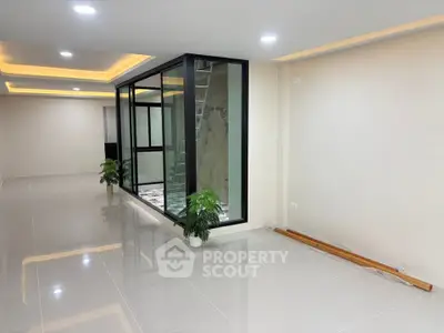 Spacious modern interior with sleek glass partition and recessed lighting