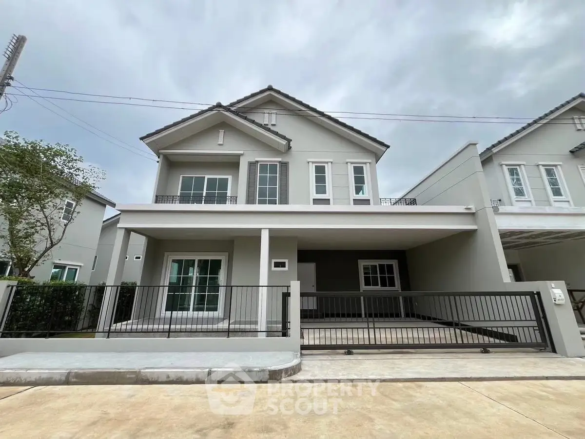 Modern two-story house with spacious driveway and contemporary design.
