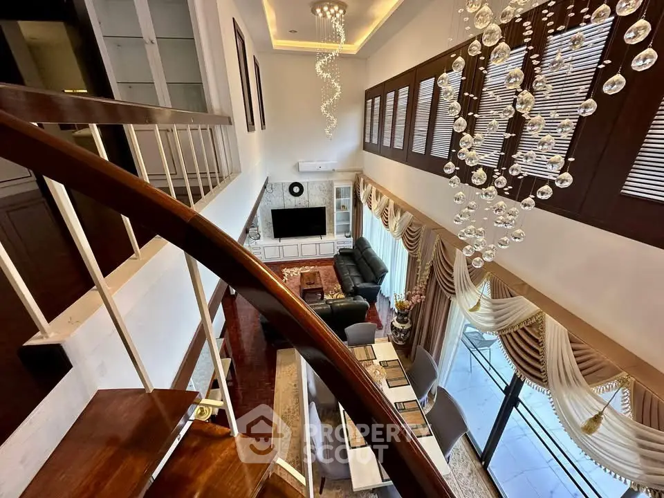 Luxurious living room with elegant chandelier and stylish staircase