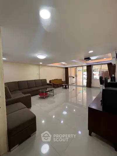Spacious living room with modern furniture and large windows for natural light.