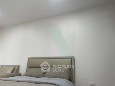 Modern bedroom with neutral tones and minimalist design, featuring a comfortable bed and sleek decor.