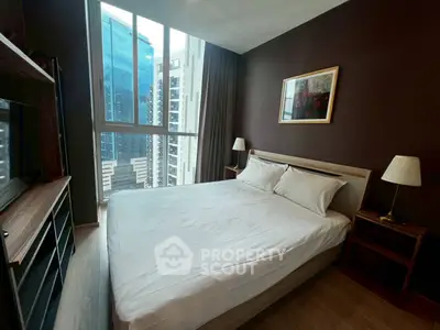 Modern bedroom with city view, featuring a cozy bed and stylish decor in a high-rise apartment.