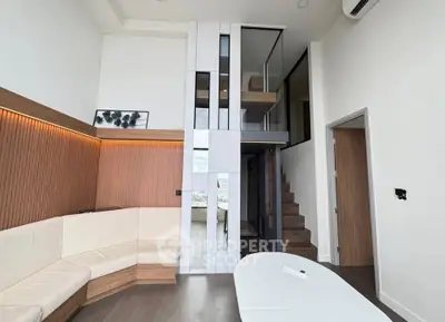 Modern duplex living room with high ceilings and stylish wood paneling