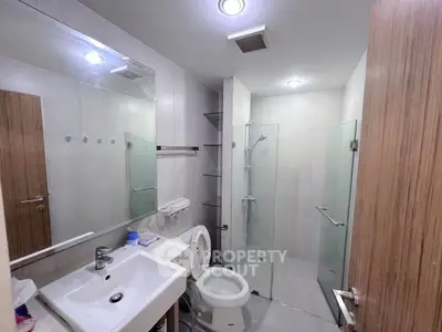 Modern bathroom with glass shower and sleek fixtures