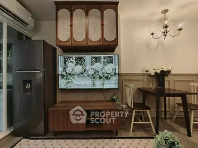Charming living room with elegant decor, featuring a mounted TV, dining area, and modern appliances.