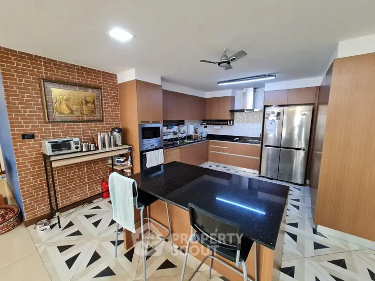 Spacious modern kitchen with sleek appliances and stylish brick accent wall