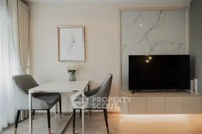 Modern living room with elegant dining area and sleek TV setup