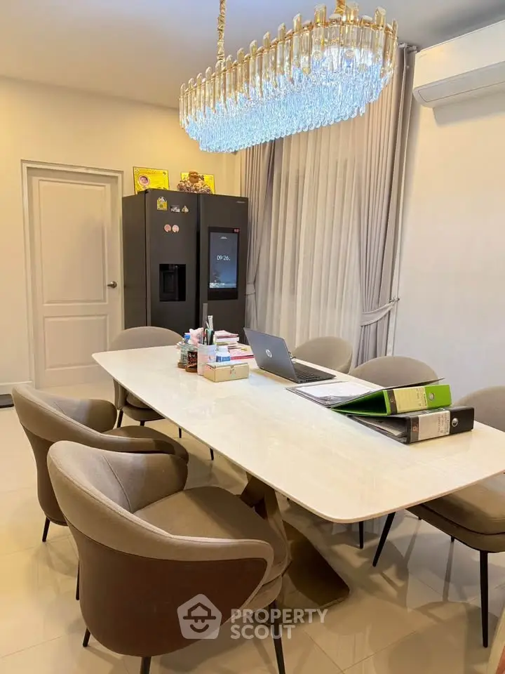 Elegant dining room with modern chandelier and sleek furniture, perfect for stylish gatherings.