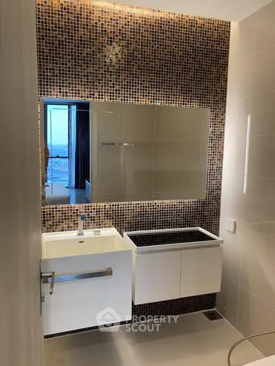 Modern bathroom with stylish mosaic tiles and sleek fixtures