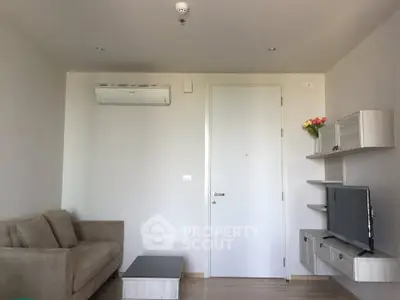 Modern living room with sleek furniture and wall-mounted TV