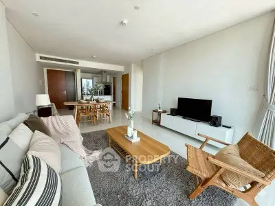 Spacious modern living room with cozy seating and open dining area