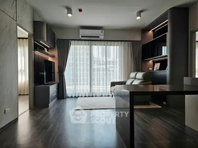Modern living room with sleek design, large window, and stylish furniture in a high-rise apartment.