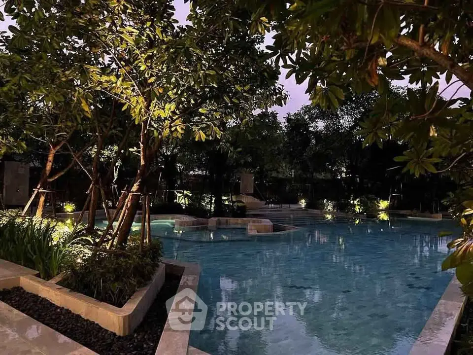 Luxurious outdoor pool surrounded by lush greenery, perfect for relaxation and leisure.