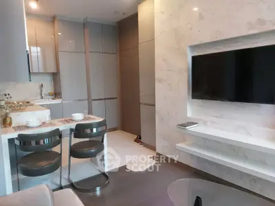 Modern open-layout kitchen and living area with sleek design and marble accents.