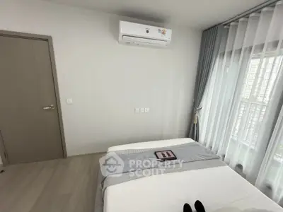 Modern bedroom with air conditioning and large window view