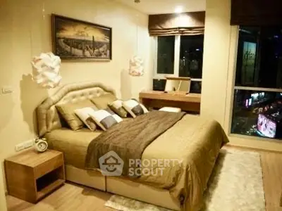 Luxurious bedroom with elegant decor and city view, featuring a plush bed and stylish lighting.