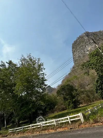 Scenic view of lush greenery and mountain backdrop, perfect for tranquil living.