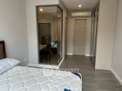 Modern bedroom with sleek design, featuring a comfortable bed and ample storage space.