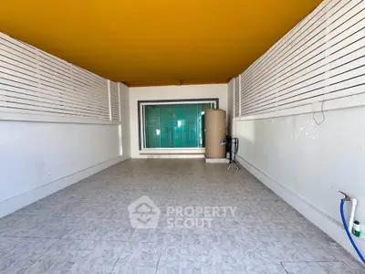 Spacious covered balcony with tiled flooring and modern design, perfect for outdoor relaxation.