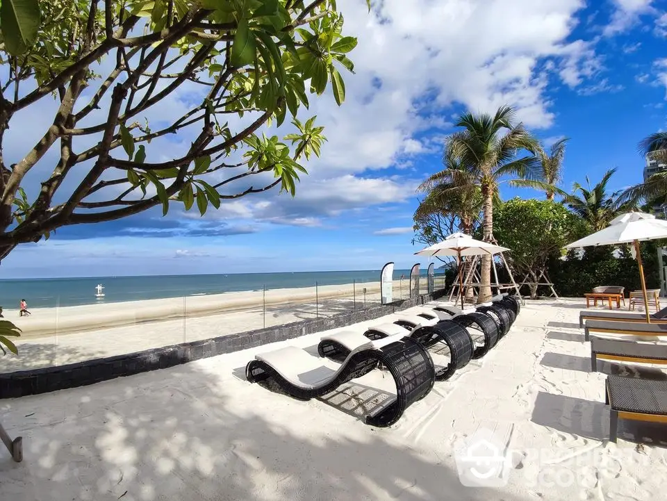 Luxurious beachfront property with stunning ocean views and relaxing lounge area.