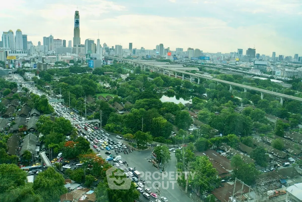 Stunning cityscape view with lush greenery and urban skyline, perfect for real estate investment.