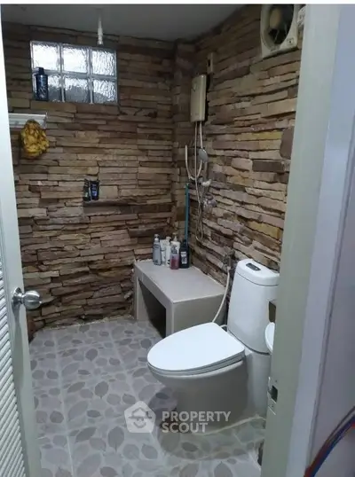 Rustic bathroom with stone walls and modern fixtures