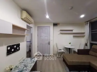 Cozy living room with modern decor and air conditioning in a stylish apartment.