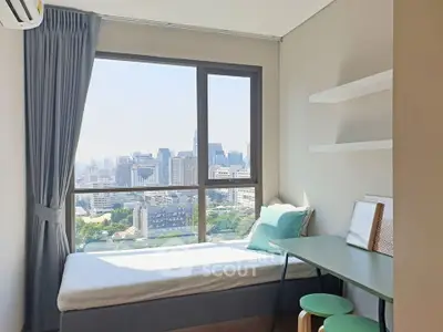 Bright bedroom with city view, featuring a cozy bed and modern decor.