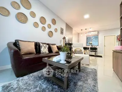 Stylish living room with modern decor and cozy seating area, perfect for relaxation and entertaining.