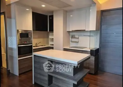 Modern kitchen with sleek cabinetry and island in contemporary apartment