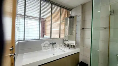 Modern bathroom with sleek design and large window blinds