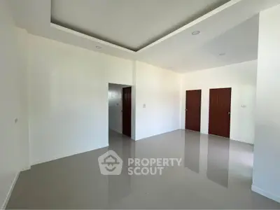 Spacious modern living room with glossy tiled floors and minimalist design