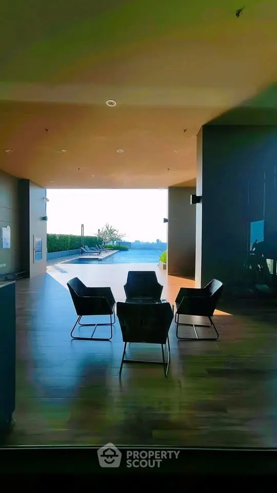 Luxurious indoor seating area with stunning pool view and modern design.