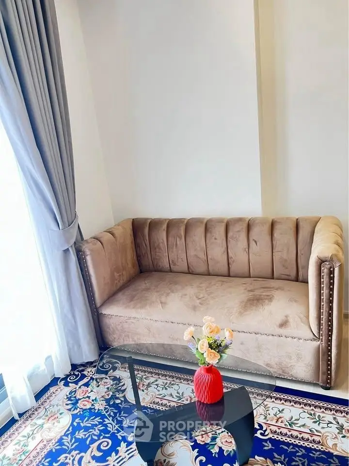 Elegant living room with plush sofa and floral decor in cozy corner.