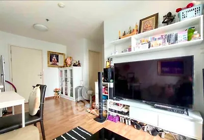 Modern living room with large TV and stylish shelving unit