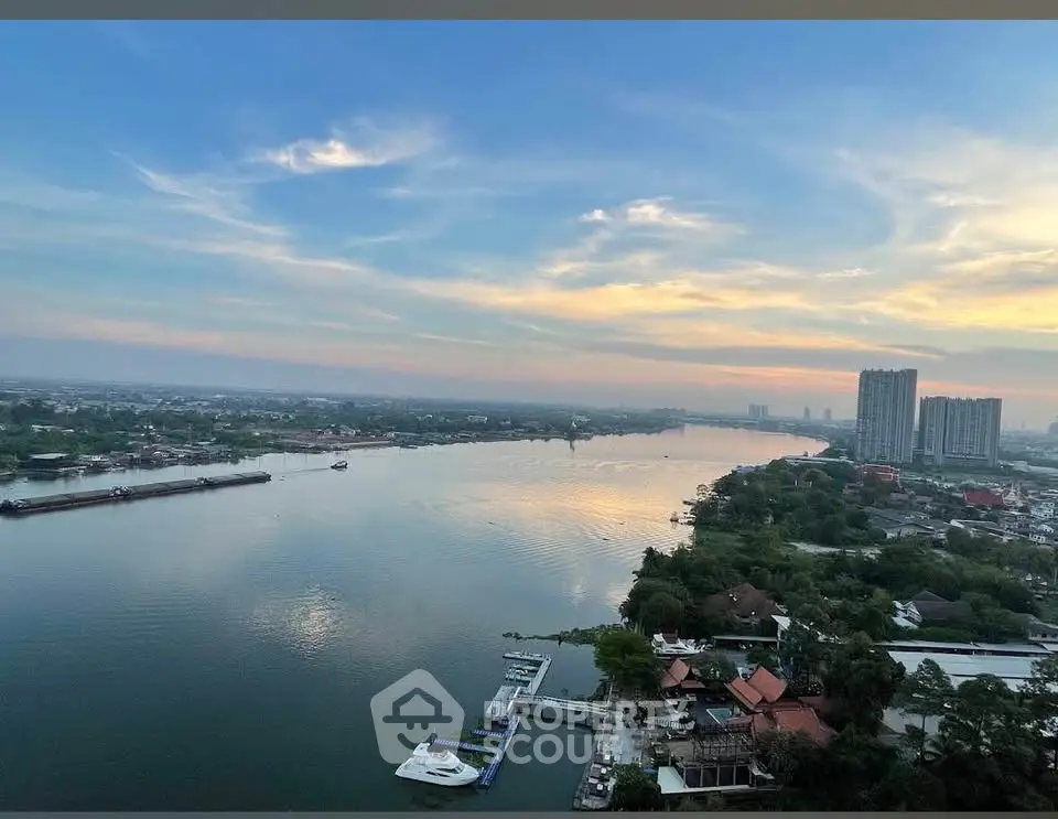 Stunning river view from high-rise apartment at sunset