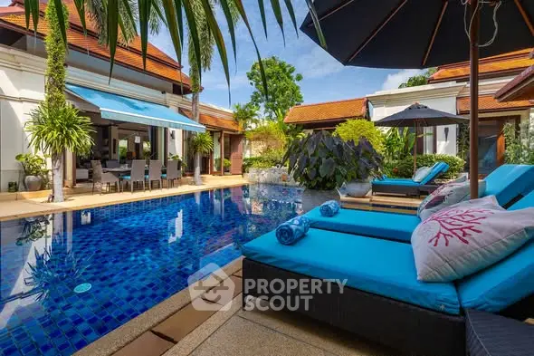 Luxurious villa with stunning pool and lush garden, perfect for relaxation and entertaining.