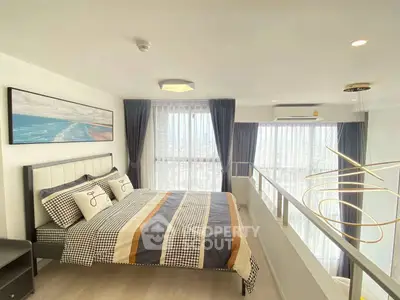 Modern bedroom with large windows and stylish decor in a high-rise apartment.