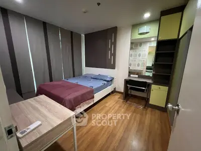 Modern bedroom with wooden flooring and stylish decor