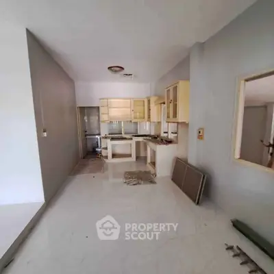 Spacious kitchen with open layout and modern cabinetry in a bright, newly renovated apartment.