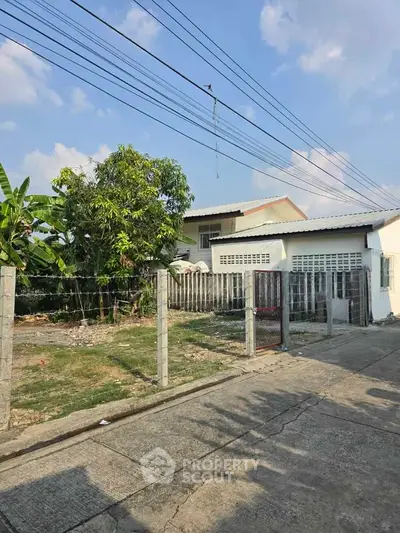 Charming suburban home with spacious yard and lush greenery, perfect for family living.